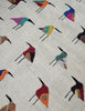 A woven Suzani rug with a light ecru linen-like background, decorated with rows of stylised bird figures in many different colours including blue, red, yellow, orange, green, and black.